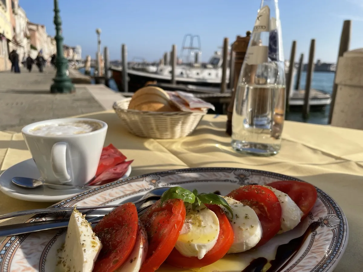 Tomato and mozzarella caprese served on the waterfront with a canal view
