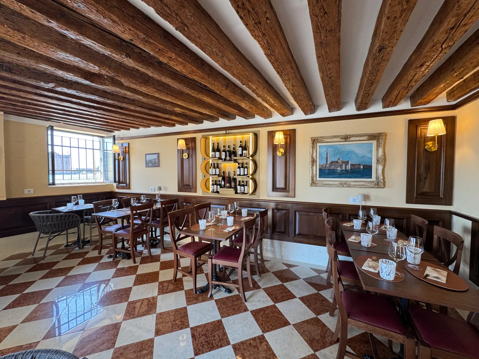Entrance of Trattoria San Basilio with outdoor tables along the Dorsoduro lane
