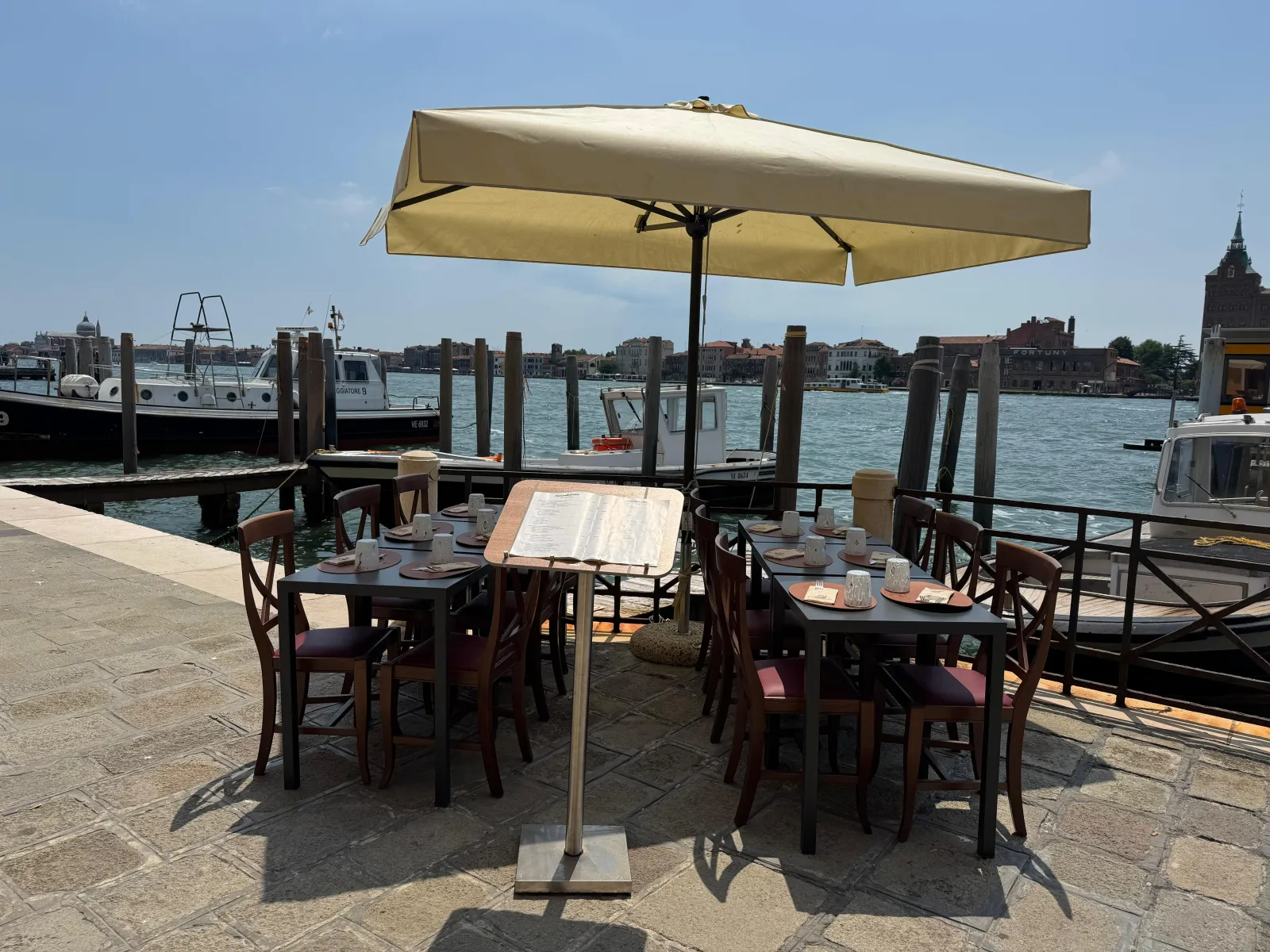 Outdoor tables of Trattoria San Basilio on the fondamenta, facing the Giudecca Canal