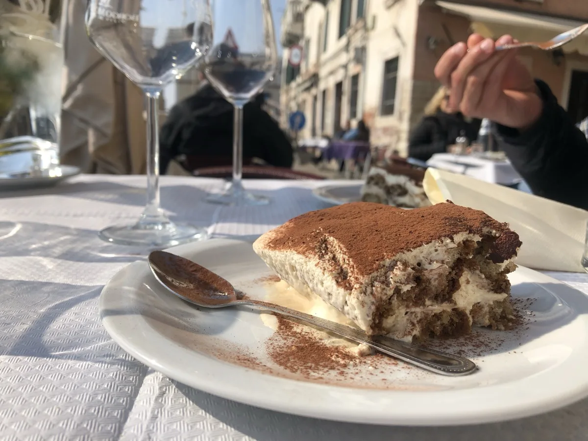 Homemade tiramisu served at an outdoor table in Venice